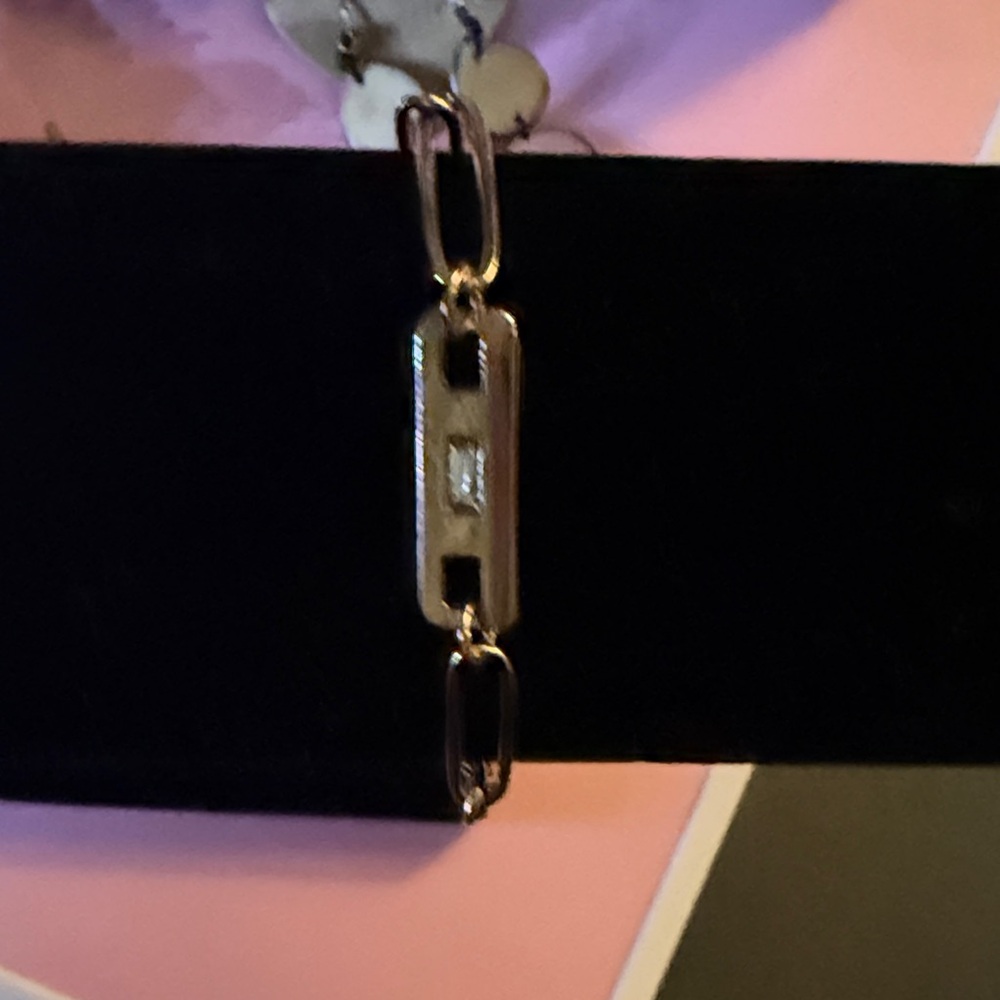 Beautiful gold tone paper clip style bracelet with grey center stone